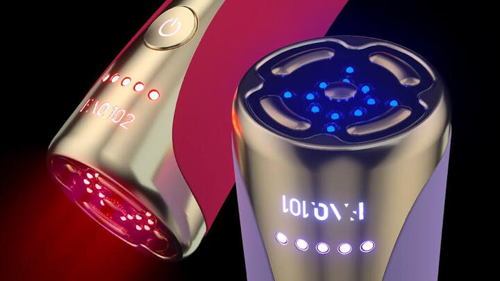 FOREO FAQ 102 devices: lavender-colored one with blue LED lights turned on at the front, and magenta-colored device in the back with red LED lights turned on